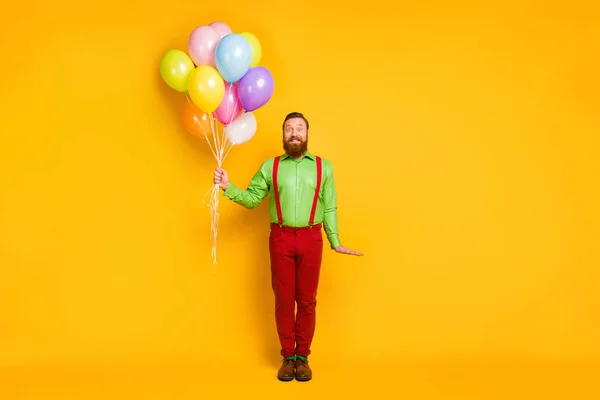 Full body photo of imposing man hold many balloons celebrate b-day event wear good look outfit isolated over vibrant color background — Stockfoto