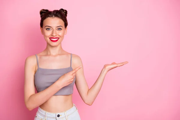 Portrait of attractive girl hold hand show index finger present summer promotion indicate adverts suggest select wear grey white outfit isolated over pastel color background — Stockfoto
