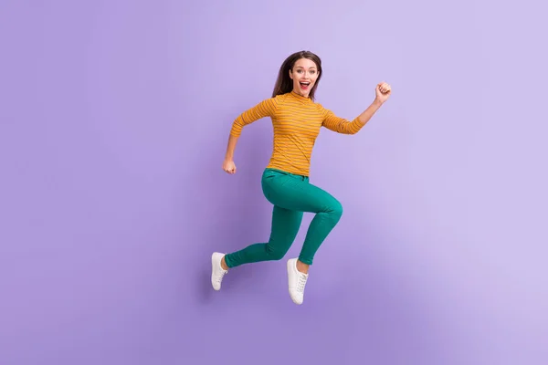 Full length body size view of nice attractive lovely cheerful cheery glad excited energetic girl jumping running fast movement isolated on violet purple lilac pastel color background — Stockfoto