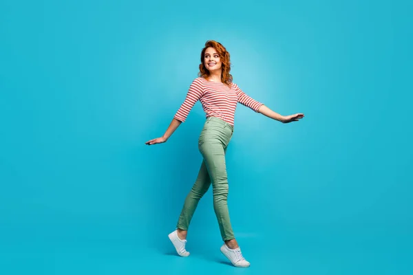 Full length profile photo of funny pretty lady enjoy warm spring day spend time walk street wear casual red white shirt green pants shoes isolated blue color background — Φωτογραφία Αρχείου