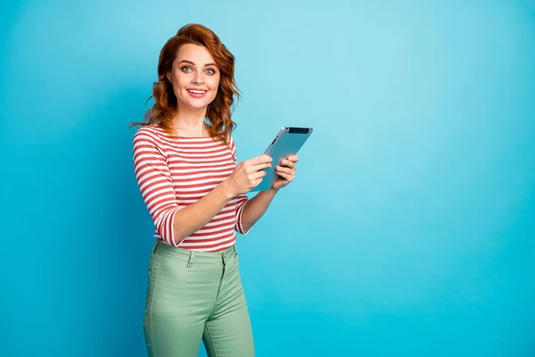 Portrait of content cute sweet girl work tablet rest relax read social media news use application wear good look sweater isolated over blue color background — Φωτογραφία Αρχείου