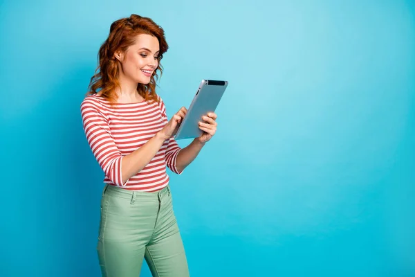 Portrait of positive cheerful woman use tablet rest relax chilling searching blog post apps wear good look jumper isolated over blue color background — 스톡 사진