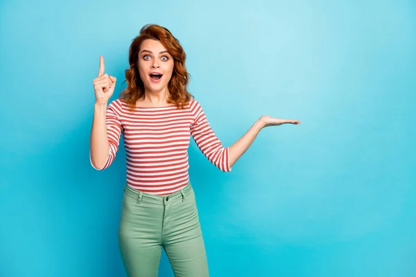 Omg its wonderful. Excited funky woman hold hand raise index finger up have incredible question answer how promote ads wear stylish white jumper isolated over blue color background — ストック写真