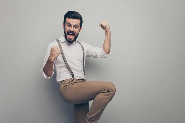 Portrait of crazy funky delighted representative agent collar man get new partnership clients investments raise fists scream yes wear brown modern clothing isolated grey color background — Stockfoto