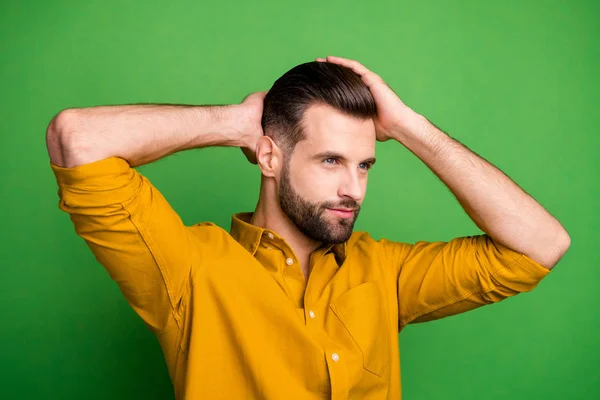 Close-up portrait of his he nice attractive muscular serious bearded guy touching hair modern coiffure haircut isolated over bright vivid shine vibrant green color background — Stock Photo, Image