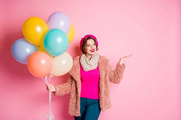 Foto von ziemlich funky Dame halten viele Luftballons Geburtstag Überraschung halten Nachrichten Produkt Geschenk om Arm tragen lässig stilvollen Pelzmantel Schal Baskenmütze Hose isoliert rosa Farbe Hintergrund — Stockfoto