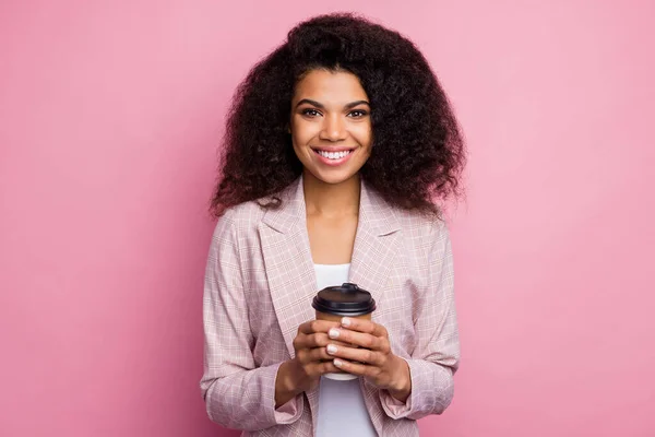 Positive cheerful afro american girl lawyer investor enjoy break pause hold mug beverage wear plaid blazer isolated over pastel pink color background — Stock Photo, Image