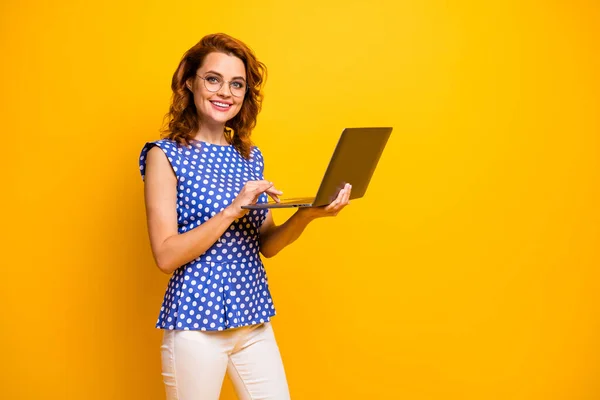 Profile photo of beautiful friendly lady hold notebook hands search information online for client customer wear specs polka-dot blue shirt white pants isolated yellow color background — Stock Photo, Image