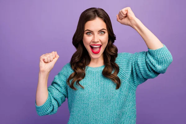 Foto von ziemlich verrückt lockige Dame gute Laune heben die Fäuste offenen Mund schreien Cheerleader Fan Sport Team Spiel tragen blau warmen Pullover isoliert lila Farbe Hintergrund — Stockfoto