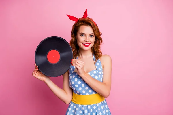 Photo of elegant lady hold old fashion vinyl cd record bring collection single to retro theme party event wear dotted dress red headband yellow belt isolated pink color background — Stockfoto