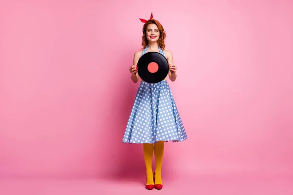 Full size photo of elegant lady old fashion vinyl cd record hands vintage retro theme party event wear dotted dress red high-heels yellow tights isolated pink color background — Zdjęcie stockowe