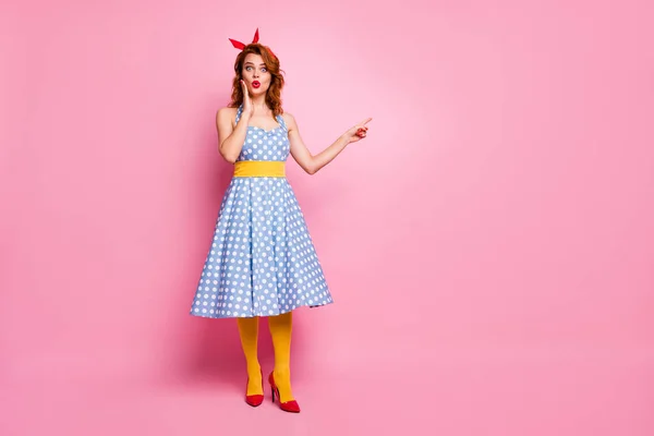 Full body photo of impressed lady look point index finger incredible discounts scream wow omg suggest pick tips wear blue polka-dot tights isolated over pink color background — Stockfoto