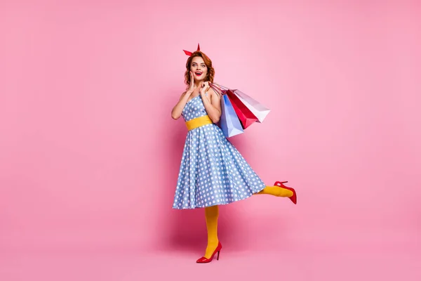 Full size photo cute sweet fancy girl tourist shopping center client enjoy off-sales bargain scream hold bags wear blue red high-heels headband yellow stockings isolated pink color background — 스톡 사진