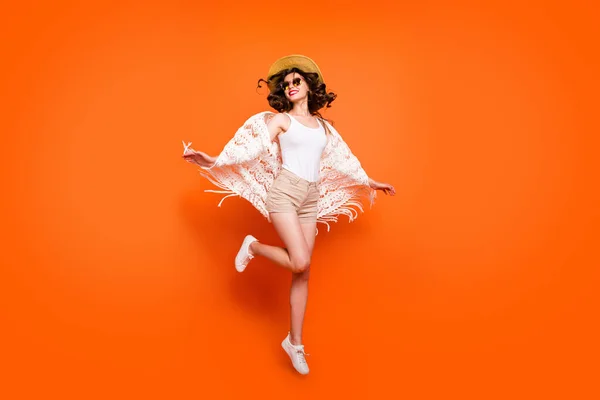 Full length photo of funny lady summer time jumping high enjoy great resort views wear stylish sun hat specs stylish white lace beach cape shorts isolated orange background — Stock Fotó