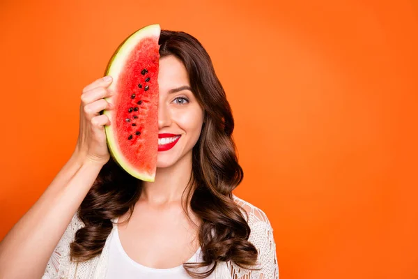 Photo of cheerful positive nice cute charming pretty girlfriend smiling toothily looking into camera with face half hidden with weage of weatermelon isolated over vivid color background — ストック写真