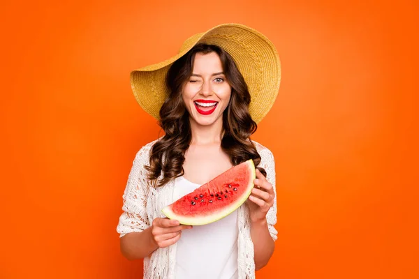 Photo of curly casual wavy nice girlish feminine youngster holding a wedge of watermelon blinking at you isolated over vivid color orange background — ストック写真