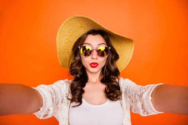 Photo of wavy cheerful cute sweet pretty white girlfriend taking sefie pouting lips on vacation isolated over vivid color orange background — Zdjęcie stockowe