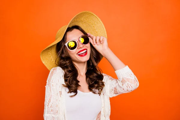 Photo of curly wavy cheerful positive nice charming pretty girlfriend in eyewear smiling toothily looking at the sun isolated over vivid orange color background — Φωτογραφία Αρχείου