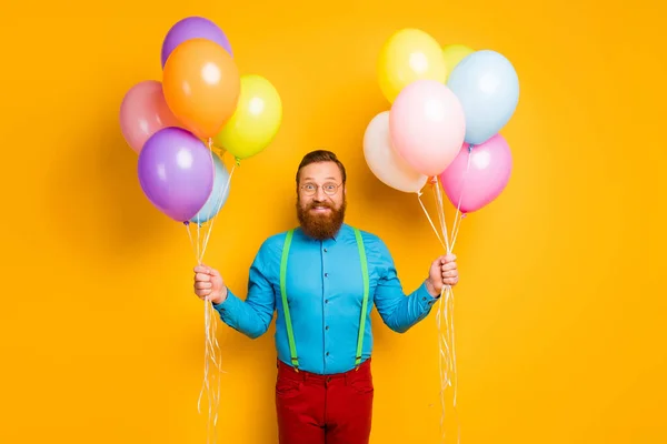 Portrait of cheerful bearded man hold many baloons he get receive on anniversary enjoy rejoice wear good look clothes isolated over bright color background — Stok fotoğraf