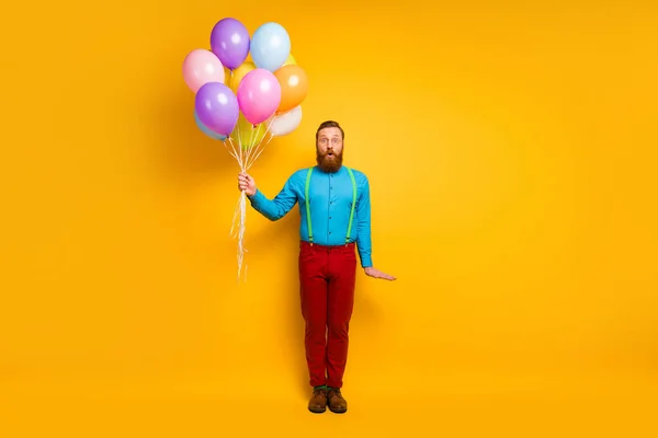 Full size photo of astonished funky crazy gentleman hold many air baloons he get on festive holiday wear modern outfit footwear isolated over bright color background — Stockfoto