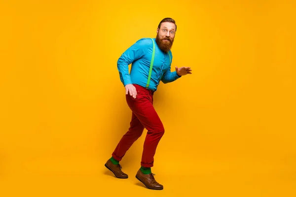 Full length body size view of his he nice attractive cheerful cheery funky guy sneaking walking tiptoe isolated over bright vivid shine vibrant yellow color background — Stock fotografie