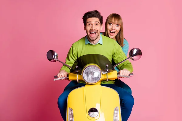 Photo of funny excited lady guy couple driving sitting speed good mood vintage yellow moped cool vacation wear casual jumper isolated pink color background — Stock Photo, Image