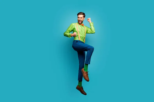 Full length body size view of his he nice attractive trendy cheerful cheery excited guy jumping celebrating having fun isolated on bright vivid shine vibrant blue teal turquoise color background — стоковое фото