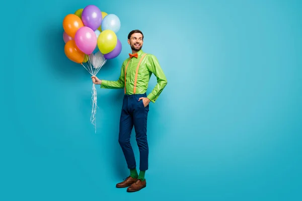 Full length body size view of nice attractive confident cheerful guy holding in hands carrying delivering air balls isolated on bright vivid shine vibrant blue green teal turquoise color background — Stockfoto