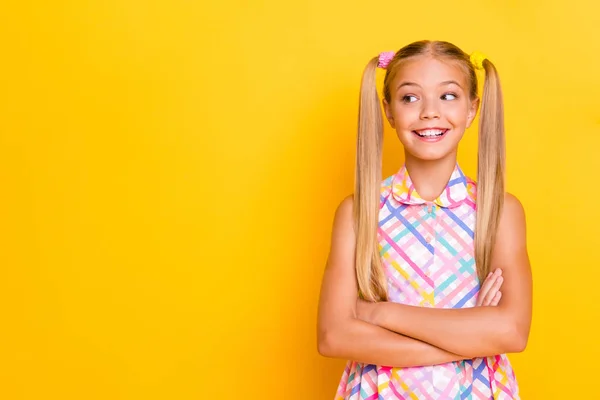 Photo of funny small lady arms crossed good mood look playful side empty space wear checkered plaid summer dress isolated yellow shine color background — Stock fotografie