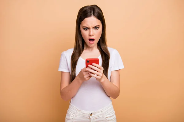Portrait of astonished negative girl use mobile phone read social media novelty wonder scream shout wear good look clothes isolated over pastel color background — Stock Fotó
