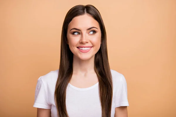 Closeup photo of beautiful pretty lady positive good mood beaming smile look side empty space wondered wear white t-shirt isolated beige pastel color background — 图库照片