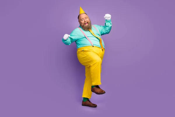Full size photo excited crazy funky overweight man win anniversary party lottery raise fists scream yes wear teal pants shoes white gloves green socks isolated violet color background — 스톡 사진