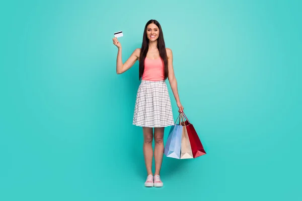 Full size photo of positive charming sweet cute girl tourist enjoy shopping use debit card hold bags bargains she buy wear white pastel shoes dress isolated over turquoise color background — Stock Fotó