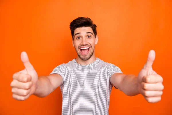 Closeup photo of crazy funny guy open mouth good news raise thumb fingers up approve express agreement wear casual striped t-shirt isolated bright orange color background — 图库照片