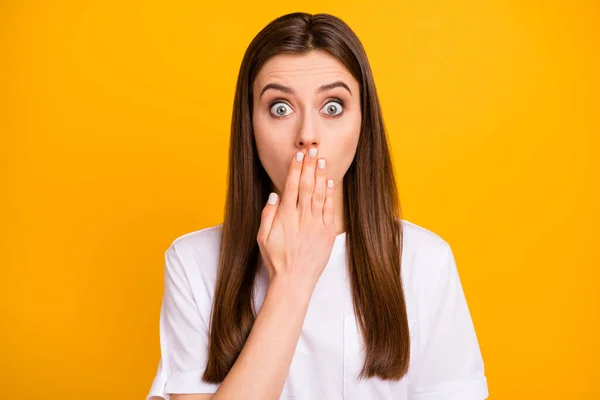 Photo of terrified pretty lady long perfect hairstyle listen bad news arm close mouth eyes full of fear epic fail wear casual white t-shirt isolated vivid yellow color background — Stockfoto