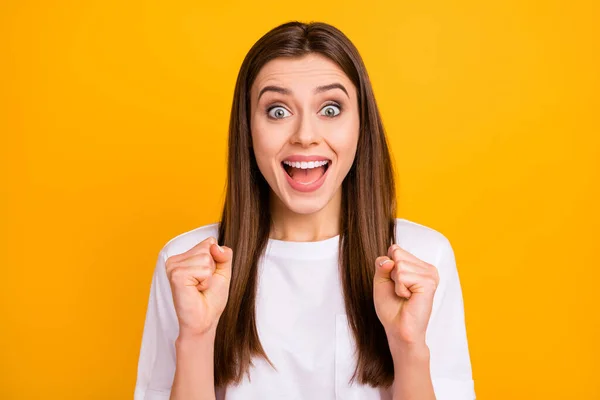 Closeup photo of crazy pretty lady long perfect hairstyle listen amazing news open mouth raise fists celebrate lottery win wear casual white t-shirt isolated vivid yellow color background — 图库照片