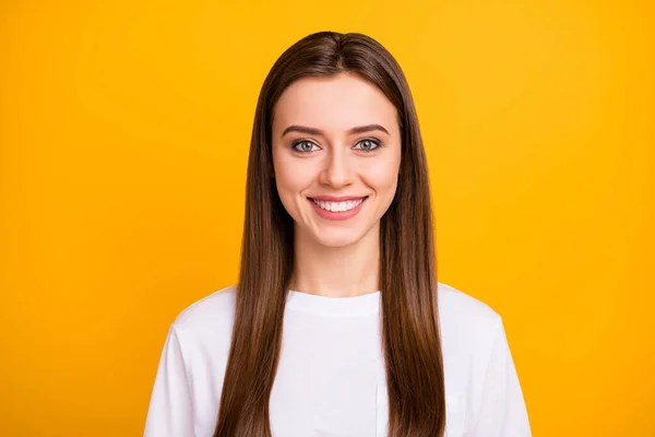 Closeup photo of cute attractive cheerful lady good mood beaming smile long perfect groomed hairdo wear casual white t-shirt isolated vibrant yellow color background — Stockfoto