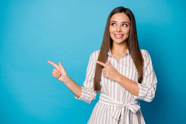 Photo of pretty attractive manager lady good mood direct fingers side empty space showing sale price shopping banner wear striped casual dress isolated blue color background — Stok fotoğraf