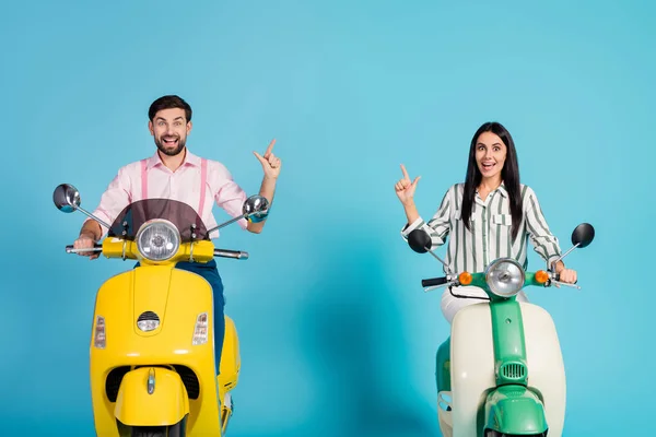 Crazy surprised shocked two people bikers drive power motor bike look incredible ads follow point index finger copyspace scream wow omg wear formalwear shirt isolated over blue color background