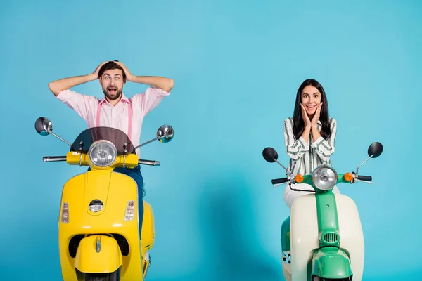 Positive crazy energetic two bikers man woman drive power motor bikes look incredible discount ads impressed touch hands cheeks face scream isolated over blue color background — Stock Fotó