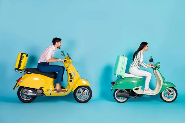 Full length profile photo of rushing airport lady guy drive two retro moped big speed bring rolling suitcases travelers formalwear clothes isolated blue color background — Φωτογραφία Αρχείου