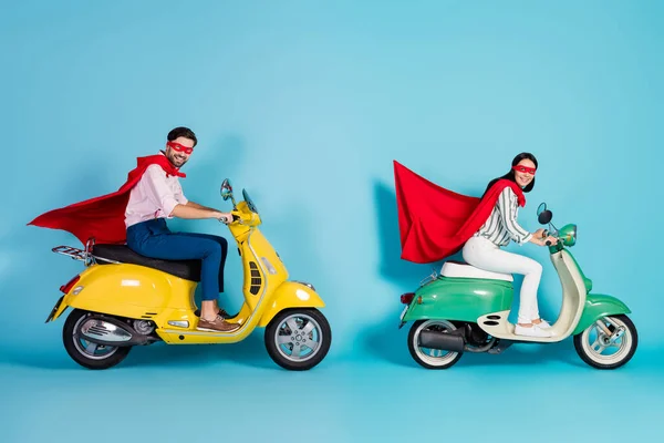 Full body profile photo of crazy lady guy drive two vintage moped wear red cape mask rushing road party play super heroes role coat flying air isolated blue color background — Zdjęcie stockowe