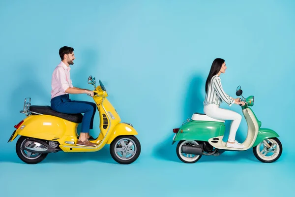 Full size profile side photo of positive cheerful man girl drive yellow green chopper enjoy freedom journey wear white striped shirt pants trousers pink isolated over blue color background — Stockfoto