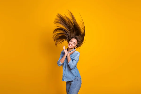 Photo of pretty amazing nice lady hairdo flying good mood presenting groomed neat long curls wear casual jeans denim outfit isolated yellow color background — Φωτογραφία Αρχείου