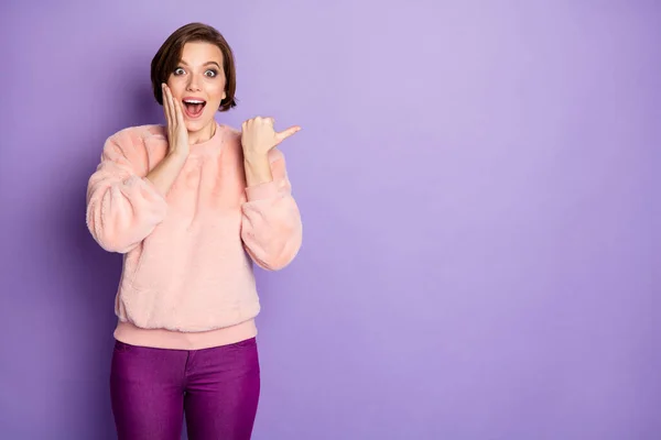 Portrait of impressed funky crazy girl promoter point thumb copyspace indicate incredible discounts promotion ads suggest select adverts wear pastel sweater isolated violet color background — Φωτογραφία Αρχείου