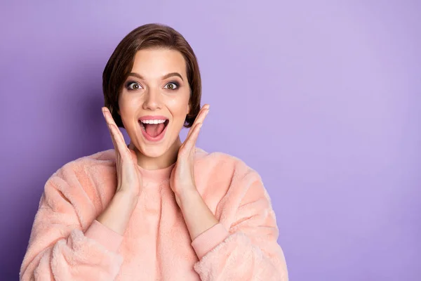 Close up photo of astonished girl hear incredible news impressed shout hold hands near face wear pastel sweater isolated over violet color background — 스톡 사진