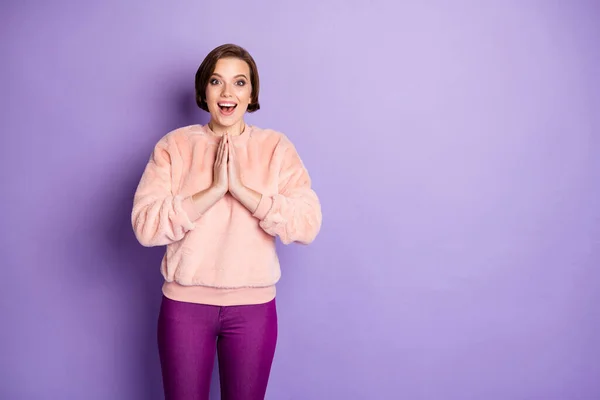 Portrait of amazed girl hear wonderful novelty she get dream surprise scream wow omg unbelievable put hands palms together wear casual style clothing isolated over purple color background — Stockfoto