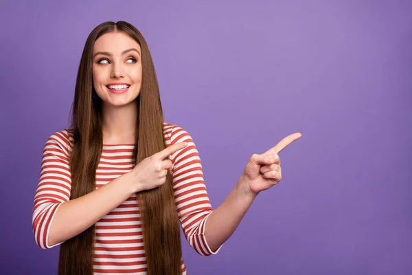 Portrait of positive cheerful girl promoter point index finger copy space direct way to sales discounts advertisements promotion wear sweater isolated over violet color background — Zdjęcie stockowe