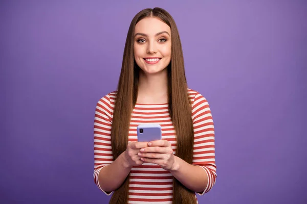 Positive cheerful charming cute pretty girl use smartphone enjoy online social media communication texting typing post comment wear good look sweater isolated violet color background — Stockfoto