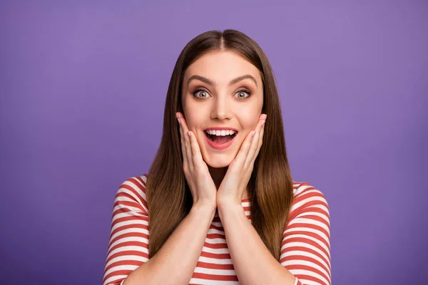 Closeup photo of attractive funny lady good mood long hairdo open mouth arms on cheeks listen great news wear casual striped shirt isolated pastel purple color background — Stock fotografie